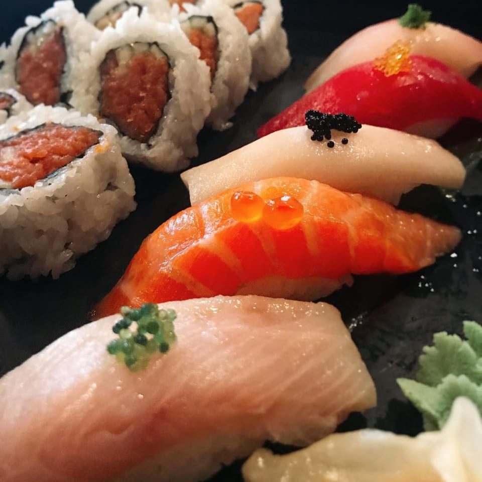 A close-up of Kanpai Izakaya's sushi platter featuring various nigiri and maki rolls.